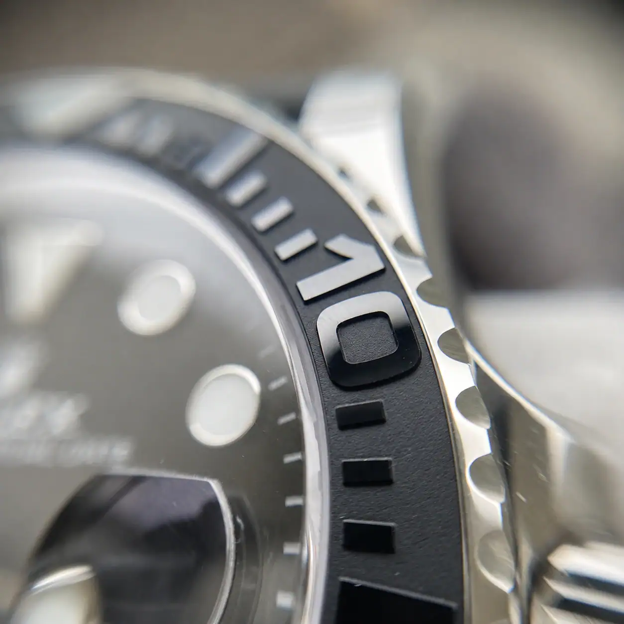Macro comparison of laser-engraved numeral kerning and chamfered edges between factory versions